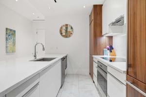 a kitchen with white countertops and a sink at Cable Beach Condo Large private patio with BBQ in Nassau
