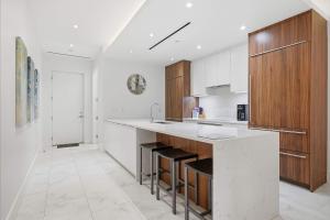 a white kitchen with a counter and a sink at Cable Beach Condo Large private patio with BBQ in Nassau
