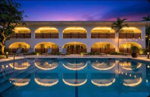 an exterior view of a hotel with a swimming pool at The Mizner Pool Suite - Boca Beachside in Boca Raton
