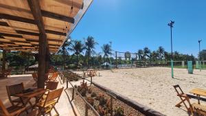 a park with tables and chairs and a playground at Barretos Park Hotel in Barretos