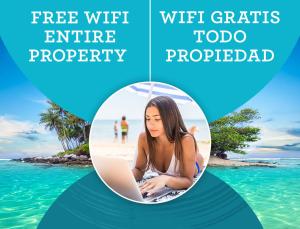 a woman sitting in the water with a laptop at PASADENA VIBES - VILLAS and SUITES - playa LOS CORALES in Punta Cana