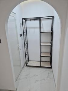 a bathroom with an arched door and a walk in shower at شاليه روز حتا - Hatta Rose Chalet in Hatta +21 photos
