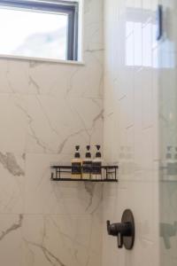 a bathroom with a shower with three bottles on a shelf at Mountain View in Orderville