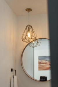 a bathroom with a mirror hanging from a wall at Mountain View in Orderville