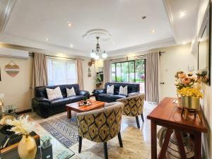 a living room with a couch and a table at Falcon Guest House in Harare