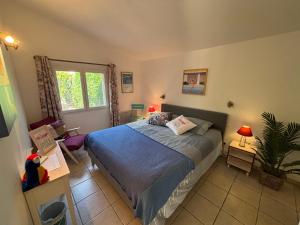 a bedroom with a bed and a plant in it at Villa Flamingo GAYmen only b&b in Marseillan +13 photos