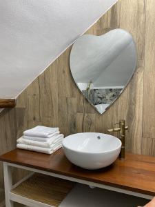 a bathroom with a sink and a mirror at The secret room in Alba Iulia