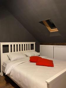 a large white bed with a red pillow on it at The secret room in Alba Iulia +15 photos