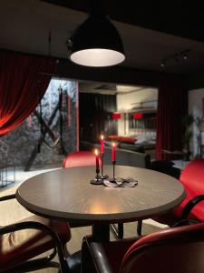 a table with candles on it in a room at The secret room in Alba Iulia