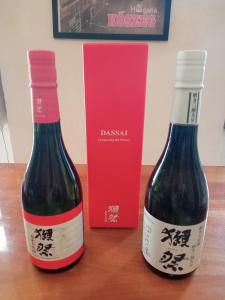 two bottles of wine on a table with a red box at Blues Ryokan in Kőszeg