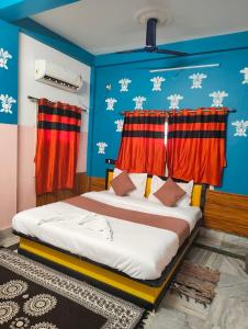 a bedroom with a bed with red curtains at Hotel Lotus in kolkata +37 photos