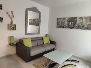 a living room with a couch and a table at Ancre Zen in Les Sables-d'Olonne