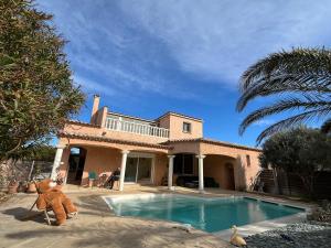 a large teddy bear sitting in front of a house at Villa Flamingo GAYmen only b&b in Marseillan