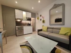 a living room with a couch and a table at Ancre Zen in Les Sables-d'Olonne