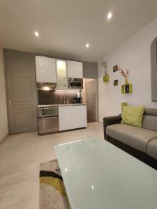 a living room with a couch and a table at Ancre Zen in Les Sables-d'Olonne