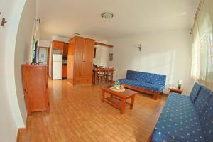 a living room with a blue couch and a table at Apartamentos La Palmera in Frontera