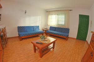 a living room with blue couches and a coffee table at Apartamentos La Palmera in Frontera +7 photos