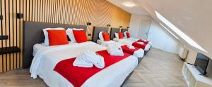 a room with four beds with red and white pillows at Durbuy House in Durbuy +95 photos