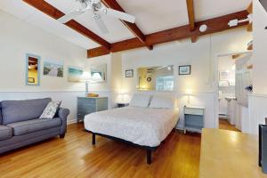 a bedroom with a bed and a couch at Sparkling Sands Holiday House M2 in Wells +42 photos