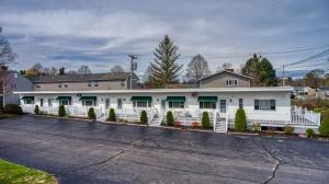 a large white building with a parking lot at Sparkling Sands Holiday House M2 in Wells