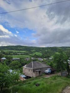an old house and a truck in a field at Tapan in Berd +11 photos