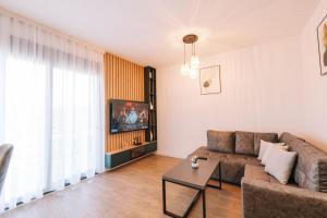 a living room with a couch and a tv at Stanovic Bungalow in Ulcinj
