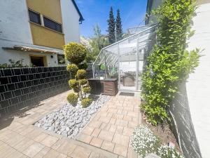 a glass house with a bench and some plants at Apartment Lahn-Paradies by Interhome in Aull