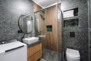 a bathroom with a sink and a toilet and a mirror at Stanovic Bungalow in Ulcinj +66 photos