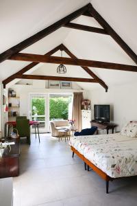 a bedroom with a bed and a living room at Schuurtje bij de IJssel in Terwolde