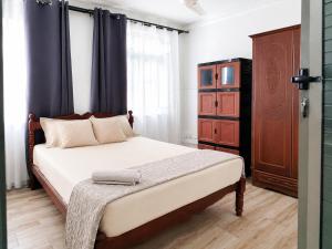 a bedroom with a large bed and a dresser at Villa Saint Malo in Pereybere +33 photos