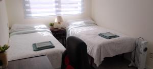 a bedroom with two beds and a window at Las Alas in Avilés