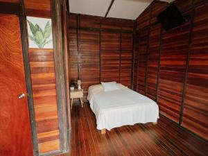a bedroom with a bed in a room with wooden walls at kbañita Huacachina in Ica +28 photos