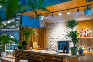 a bar with potted plants on top of it at Hotel Fabio in Ksamil