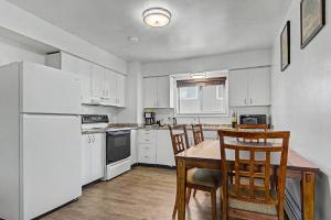 a kitchen with white appliances and a table and chairs at 410 e 45th ave unit 4 in Anchorage