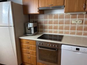 a kitchen with a stove top oven next to a refrigerator at Ubytování Jívka 86 in Jívka