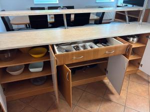 a kitchen counter with wooden drawers and shelves at Ubytování Jívka 86 in Jívka
