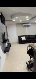 a living room with a couch and a table at APARTAMENTo CUMBRES ANDINAS 3 Hab 5 personas in San Cristóbal