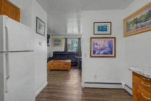 a kitchen with a refrigerator and a living room at 410 e45th 2 bedroom apartment in Anchorage