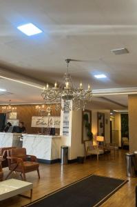 a lobby with a bar and a chandelier at Éden Hotel in Rio Verde +74 photos
