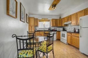 a kitchen with wooden cabinets and a table and chairs at 410 E 45th ave Unit 3 in Anchorage