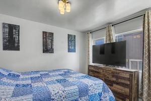 a bedroom with a bed and a flat screen tv at 410 E 45th ave Unit 3 in Anchorage