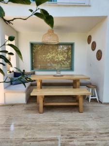a living room with a table and a bench at Nunu GARDEN Urla in Urla