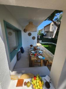 a balcony with a table with plates of fruit on it at Nunu GARDEN Urla in Urla