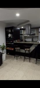 a kitchen with a table and two chairs in it at APARTAMENTo CUMBRES ANDINAS 3 Hab 5 personas in San Cristóbal