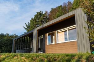 a small house with a large garage at Petricor Ecolodge Cab2 in Pucón +18 photos