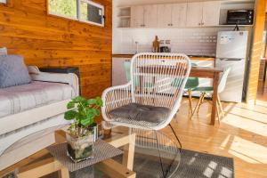 a living room with a chair and a table at Petricor Ecolodge Cab2 in Pucón