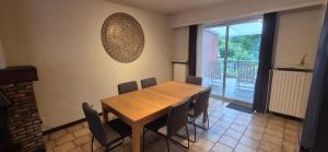 a dining room with a wooden table and chairs at CoSY HOME in Mortsel