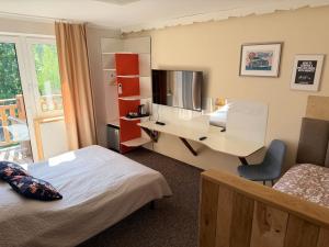 a hotel room with two beds and a desk at Kasztanowe Wrota in Kosewo