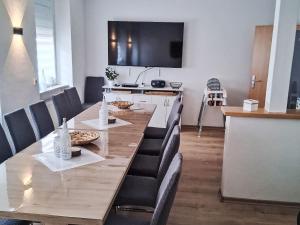 a dining room with a long table and chairs at Holiday Home L by Interhome in Kövenig