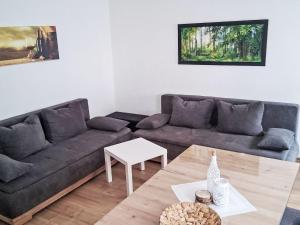 a living room with a couch and a table at Holiday Home L by Interhome in Kövenig